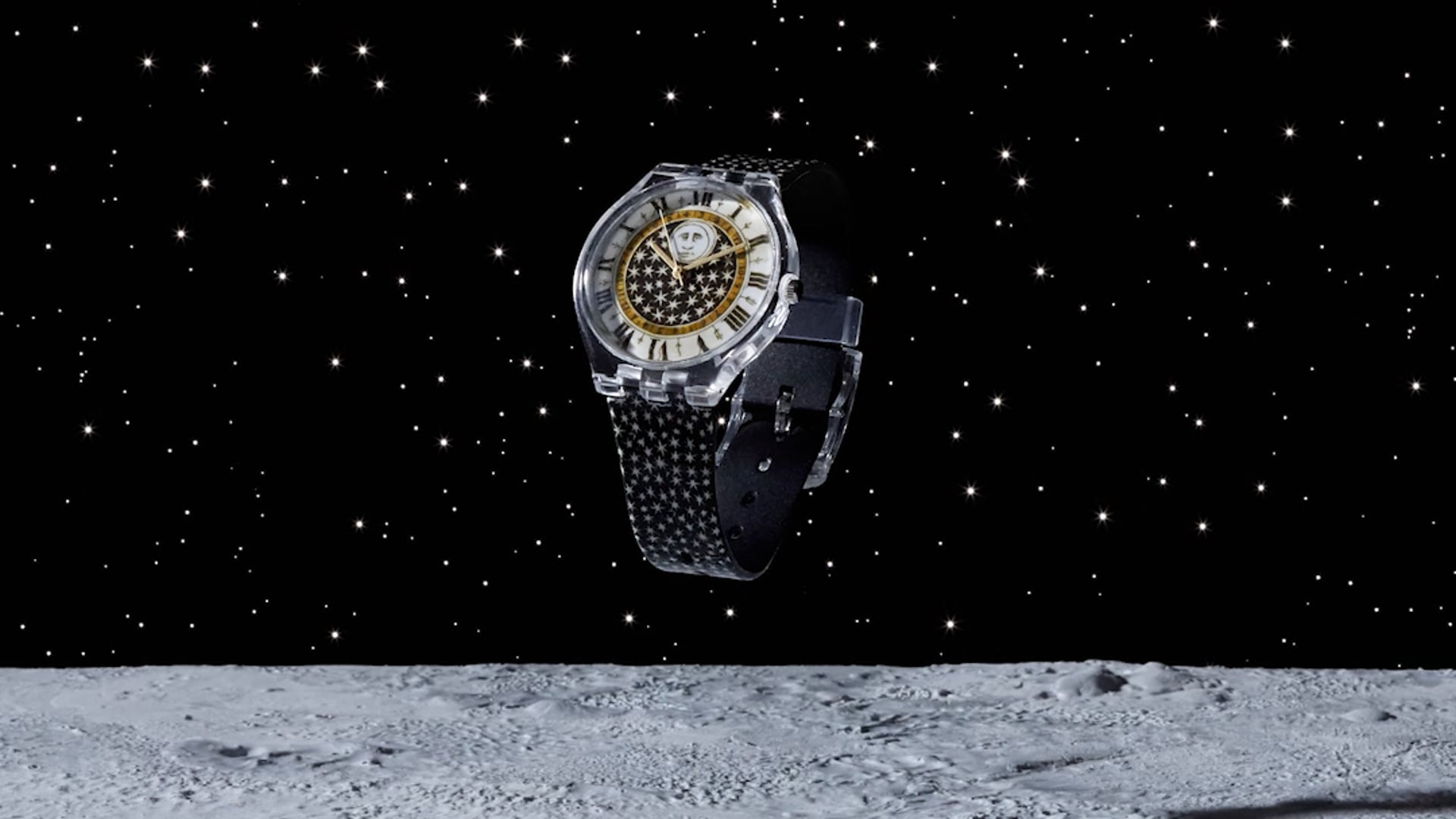 video of a wristwatch with a clear bezel, moon and stars themed face, and star band floating over a moonscape as the stars fall behind the horizon